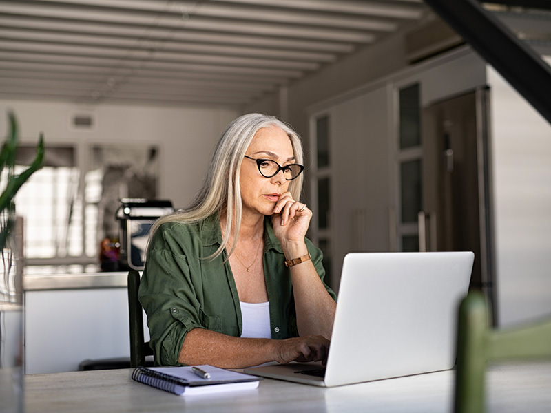 Femme retraitée travaillant à l'ordinateur